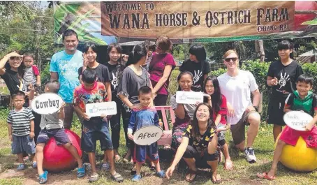  ??  ?? Daniel Smith with children from Destiny Rescue at Wana Horse and Ostrich Farm in Chiang Rai province.