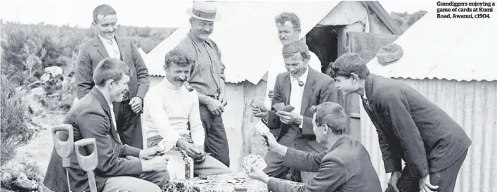  ??  ?? Gumdiggers enjoying a game of cards at Kumi Road, Awanui, c1904.