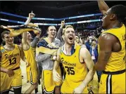  ?? STREETER LECKA / GETTY IMAGES ?? Playing with poise while dismantlin­g the nation’s best defense, Maryland-Baltimore County made all the right moves and busted brackets by pulling off one of the most stunning upsets in sports history: No. 16 seed UMBC 74, No. 1 Virginia 54.