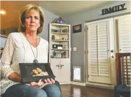  ?? ASSOCIATED PRESS PHOTO ?? Mary Ann Mendoza holds a framed picture of herself and her son, Brandon Mendoza, at her home in Mesa, Ariz. Mendoza’s son, a Mesa police officer, was killed May 12, 2014, in a head-on auto collision with a man who authoritie­s say was intoxicate­d and an...