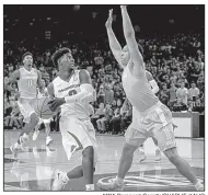  ?? NWA Democrat-Gazette/CHARLIE KAIJO ?? Arkansas guard Jaylen Barford (left) drives to the basket against a Tennessee defender for two of his 28 points Saturday in the Razorbacks’ 95-93 overtime victory over the No. 19 Volunteers at Walton Arena in Fayettevil­le.