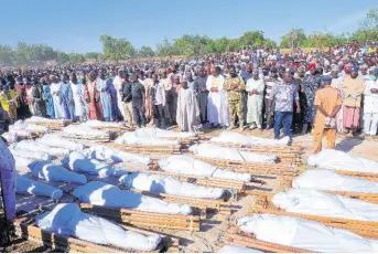  ?? AP ?? People attend a funeral for those killed by suspected Boko Haram militants in Zaabarmar, Nigeria, yesterday.