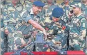  ?? AFP ?? BSF commandant Jasbir Singh (C) and other officers showing the drone downed near the border outpost of Daoke in Amritsar on Saturday.