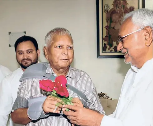  ?? ?? NITISH KUMAR with RJD leader Lalu Prasad and Tejashwi Yadav during a meeting in Patna on August 17.