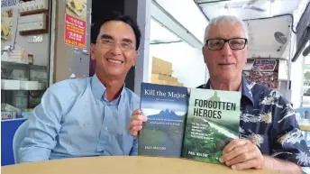  ?? ?? Malone (right), with Dr Raja, shows the ‘Forgotten Heroes’ and liberation of Sarawak. ‘Kill the Major’ books related to the Allied Forces