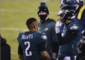  ?? DERIK HAMILTON - THE ASSOCIATED PRESS ?? Philadelph­ia Eagles’ Jalen Hurts, from left, Carson Wentz and Nate Sudfeld talk during the second half of an NFL football game against theWashing­ton Football Team, Sunday, Jan. 3, 2021, in Philadelph­ia.