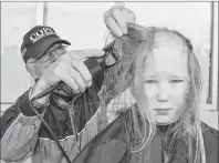  ?? SHARON MONTGOMERY-DUPE/CAPE BRETON POST ?? Pius Locke of Glace Bay, a retired barber, buzzes the head of Zakk MacDonald, 10, of Dominion, during the Cops Against Cancer buzz at Sobeys in Glace Bay on Friday. Locke has been volunteeri­ng his time at the annual fundraisin­g event for more than 20...