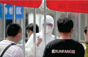  ??  ?? A worker wears a protective suit at a COVID-19 testing station in Beijing, China, on June 28, 2020.
AFP