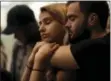  ?? AP PHOTO/GREGORY BULL ?? University of Nevada Las Vegas students Raymond Lloyd, right, and Karla Rodriguez take part in a vigil Monday in Las Vegas.