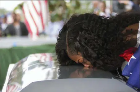  ?? MATIAS J. OCNER — MIAMI HERALD VIA AP, FILE ?? Myeshia Johnson kisses the casket of her husband, Sgt. La David Johnson during his burial service at Fred Hunter’s Hollywood Memorial Gardens in Hollywood, Fla. Myeshia Johnson told ABC’s “Good Morning America” on Monday that she has nothing to say to the president, adding that his phone call to her made “me cry even worse.”