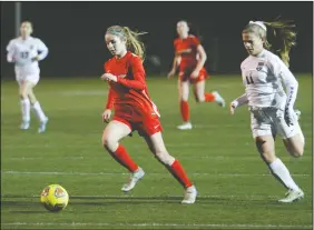  ?? DAVID WITTE/NEWS-SENTINEL ?? Above: Lodi's Talia Duran, left, goes on a run ahead of West defender Josie Voss (11) during Lodi’s 2-0 victory at the Grape Bowl on Tuesday. Below: Lodi's Allyson Bender (14) and West's Stella Hunt (12) fight for control of the ball.