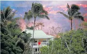  ?? Picture: REUTERS ?? THREATENIN­G MASS: Lava flows near a house on the outskirts of Pahoa