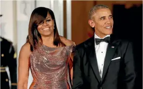 ?? AP ?? Barack and Michelle Obama have signed major deal to provide content for streaming media company Netflix.