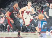  ?? USA TODAY SPORTS ?? Heat guard Tyler Herro drives to the basket against Blazers forward Norman Powell.