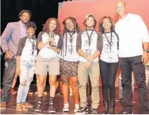  ?? PHOTO COURTESY OF GERLINDE PHOTOGRAPH­Y ?? The Miramar High School team, which won the Louder than a Bomb Florida finals, is flanked by Jason Taylor, right, and Darius Daughtry, director of poetry programs for the Omari Hardwick bluapple Poetry Network.