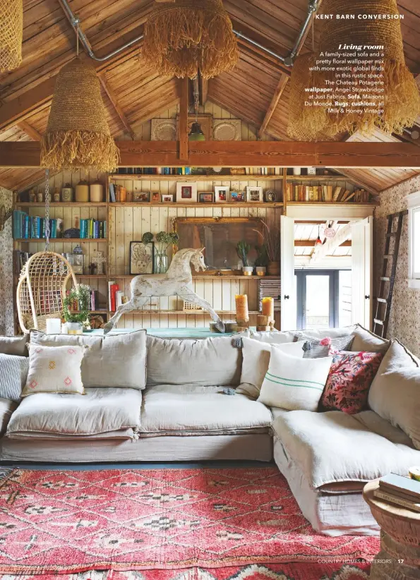  ??  ?? Living room A family-sized sofa and a pretty floral wallpaper mix with more exotic global finds in this rustic space. The Chateau Potagerie wallpaper, Angel Strawbridg­e at Just Fabrics. Sofa, Maisons Du Monde. Rugs; cushions, all Milk & Honey Vintage