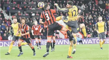  ??  ?? Arsenal’s Olivier Giroud scores the third goal during the English Premier League football match against Bournemout­h at the Vitality Stadium in Bournemout­h, southern England. — Reuters photo