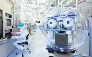  ?? PROVIDED TO CHINA DAILY ?? An employee operates the working system in Infineon’s smart factory in Dresden, Germany.