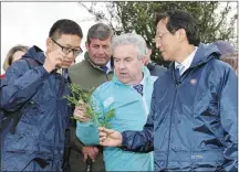  ??  ?? All members of the Chinese delegation were hugely interested in all aspects of Irish farming.LEFT:The Chinese delegation, Junior Minister for Agricultur­e Andrew Doyle, personnel from Teagasc and Bord Bia, and Declan O’ Keeffe and Gene O’ Connor of Boherbue Co-Op, pictured with the Murphy at their family farm in Boherbue on Friday.BELOW LEFT: On behalf of the Murphy family, Róisín presented a gift to Mr Han Changfu to mark his visit to Boherbue.FAR LEFT: Mr Han Changfu chatting to Gene O’ Connor, Chairman of Boherbue Co-Op and CEO Declan O’ Keeffe who outlined the role of the Co-Op in the local community.