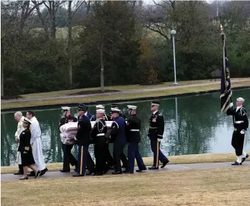  ??  ?? The flag-draped casket of Bush is carried by a joint services military honour guard for burial at the George H W Bush Presidenti­al Library and Museum in College Station, Texas. —Reuters photo