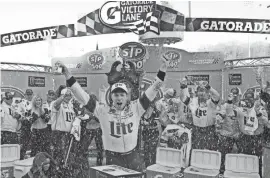  ?? AP ?? Brad Keselowski celebrates after winning the NASCAR Cup Series race Sunday at Martinsvil­le Speedway. It was his first victory at the track.