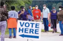  ?? BEN GRAY/ATLANTA JOURNAL-CONSTITUTI­ON ?? People wait to vote in Decator, Ga., on Oct. 12. Election experts predict a record 150 million votes may be cast in this election, with turnout rates higher than in any presidenti­al election since 1908.