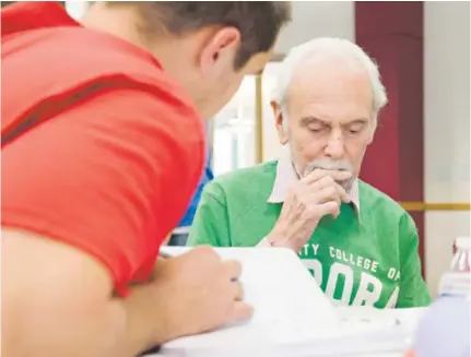  ?? Brent Lewis, The Denver Post ?? Dan Dillon, an Alzheimer’s resident at Emeritus at Denver, visits with Mat Romero, an 18-year-old student at Community College of Aurora, on Tuesday. Romero, whowas interviewi­ng Dillon on campus for the second time, and 19 other CCA students were...