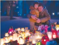  ?? AP PHOTO ?? People light candles to commemorat­e the victims of Sunday’s fire in a shopping mall in the Siberian city of Kemerovo, in front of the Russia’s Embassy in Vilnius, Lithuania, Tuesday.