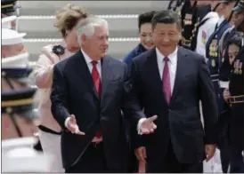  ?? THE ASSOCIATED PRESS ?? Secretary of State Rex Tillerson, left, walks with Chinese president Xi Jinping at the Palm Beach Internatio­nal Airport in West Palm Beach, Fla.