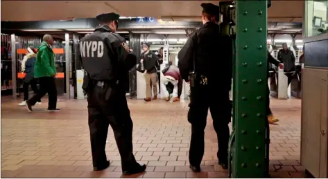  ??  ?? New York City police officers observe commuters using turnstiles at a Harlem subway station in New York on March 3, 2016. New York City police and transit officials say a new policy not to prosecute subway fare jumpers could embolden criminals and...