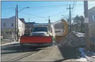  ??  ?? Crews from Cohoes Department of Public Works are seen out on Columbia Street Wednesday morning removing large snow banks from the side of the street.