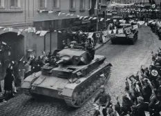  ??  ?? ■ In October 1938, the Panzertrup­pe showed a spectacula­r presence during the ‘liberation’ of the Sudentenla­nd. Here, a Panzer IV of 4th Coy travelling through the main street of Komotau and past thrilled Germans.