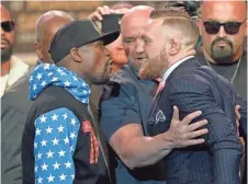  ?? GARY A. VASQUEZ, USA TODAY SPORTS ?? Promoting their Aug. 26 fight, Floyd Mayweather Jr., left, and Conor McGregor face off Tuesday in Los Angeles.