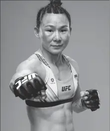  ?? ZUFFA LLC ?? Zhang Weili (left) and Yan Xiaonan do battle on Saturday, when the UFC women’s strawweigh­t belt will be on the line.