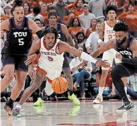  ?? CHRIS COVATTA TRIBUNE NEWS SERVICE FILE PHOTO ?? Marcus Carr, middle, and his Texas Longhorns enter the men’s NCAA March Madness tournament as the second seed in the Midwest Region.