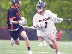  ?? Dave Stewart / Hearst Connecticu­t Media ?? New Canaan’s Hayden Shin (7) comes up with the ball during a faceoff, while Ridgefield’s Terry Li pursues at Dunning Field in New Canaan on Saturday.