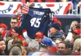  ?? THE ASSOCIATED PRESS ?? Supporters wave a jersey supporting President Donald Trump before he arrives at a campaign rally for a Pennsylvan­ia congressio­nal candidate last weekend.