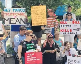  ?? STEVEN LEMONGELLO/STAFF ?? Protesters rally Tuesday against the Senate Republican health care bill outside Marco Rubio’s office in Orlando.