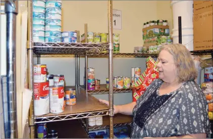  ?? TAMMY KEITH/RIVER VALLEY & OZARK EDITION ?? Judi Lively, executive director of Bethlehem House, a transition­al homeless shelter in Conway, looks at the sparse shelves in the pantry. Lively said donations of food and money are typically down in the summer.