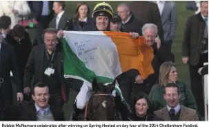  ??  ?? Robbie McNamara celebrates after winning on Spring Heeled on day four of the 2014 Cheltenham Festival