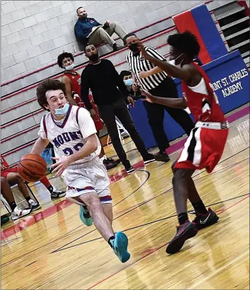  ?? Photo by Ernest A. Brown ?? Connor Robillard, above, and the Mount St. Charles boys basketball team improved to 2-1 in Division III with a 55-37 win over Juanita Sanchez Tuesday night.