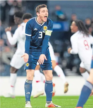  ?? Pictures: PA/SNS Group. ?? Left: Steven Naismith fires in Scotland’s late consolatio­n after Gary Mackay-Steven’s clever backheel had played him in; above: captain Andy Robertson wants answers after Bruma netted Portugal’s third goal; below: Graeme Shinnie challenges Portugal’s Renato Sanches.