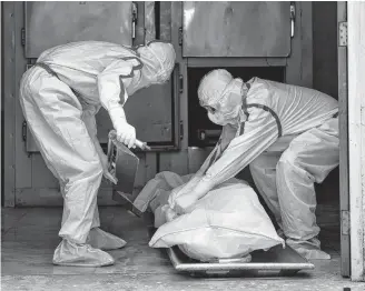  ?? REUTERS ?? Mortuary workers prepare to transport the body of a person who died from COVID-19 at Max Smart Super Speciality Hospital in New Delhi, India on Thursday.