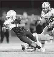  ??  ?? LONG BEACH POLY’S Jaden Wade is brought down by Mission Viejo’s Mitch Dossey.