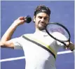  ?? Kevork Djansezian / Getty Images ?? Roger Federer tosses a wrist band to the crowd.