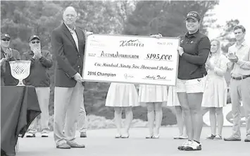  ?? AFP PHOTO ?? Ariya Jutanugarn of Thailand receives a check after winning the Kingsmill Championsh­ip at Kingsmill Resort on May 22, 2016 in Williamsbu­rg, Virginia.