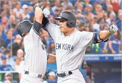  ?? NICK TURCHIARO/USA TODAY ?? Giancarlo Stanton celebrates a two-run homer Thursday with Yankees teammate Brett Gardner.