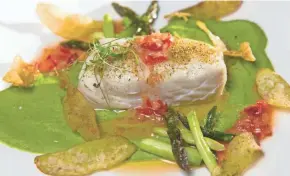  ?? MILWAUKEE JOURNAL SENTINEL MARK HOFFMAN, ?? Alaskan halibut was served with pea puree, asparagus, pickled pepper and fingerling potato at Third Coast Provisions, 724 N. Milwaukee St.