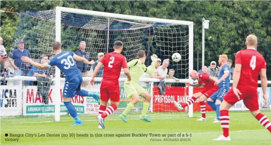  ?? Picture: RICHARD BIRCH ?? Bangor City’s Les Davies (no 30) heads in this cross against Buckley Town as part of a 5-1 victory