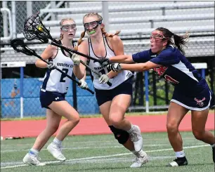  ?? Photo by Ernest A. Brown ?? Burrillvil­le freshman Jenna Forrest, center, was third on the Division III champion Broncos with 16
goals. The middie also added 15 ground balls and 21 defensive clearances.